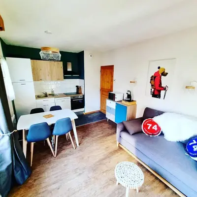 a living room with a couch and a table at Appartement avec piscine & jardin pied de la télécabine in Saint-Gervais-les-Bains