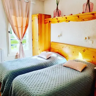 a bedroom with two twin beds and a window at Appartement avec piscine & jardin pied de la télécabine in Saint-Gervais-les-Bains