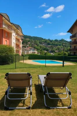 two chairs sitting in front of a tennis court at Appartement avec piscine & jardin pied de la télécabine in Saint-Gervais-les-Bains