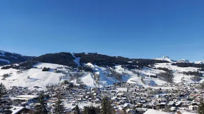 a town covered in snow on a mountain at Lune D'Argent Appartement avec vue sur la montagne in Megève