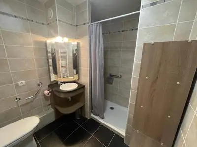 a bathroom with a sink and a toilet and a shower at Lune D'Argent Appartement avec vue sur la montagne in Megève