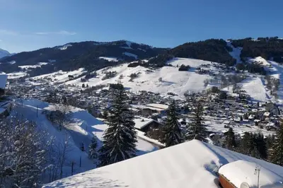 a town in the snow on a mountain at Lune D'Argent Appartement avec vue sur la montagne in Megève