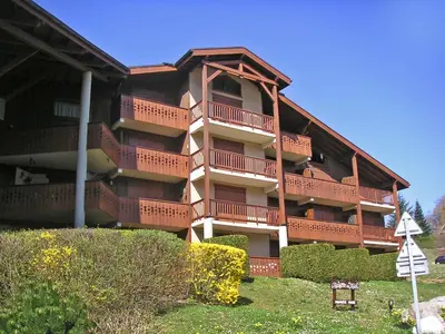 an apartment building with a lawn in front of it at Apartment Aiguilles du Midi by Interhome in Saint-Gervais-les-Bains