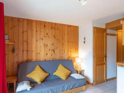 a kitchen with a table and a white refrigerator at Apartment Aiguilles du Midi by Interhome in Saint-Gervais-les-Bains