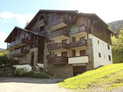 a building with balconies on the side of it at Studio cosy 4 pers avec parking, lave-vaisselle, balcon, proche des pistes et commerces - FR-1-572-56 in Arâches-la-Frasse