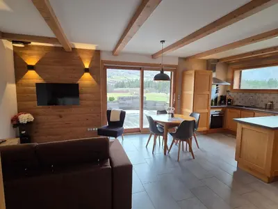 a living room with a couch and a table with chairs at Appartement calme 2 chambres avec terrasse à Samoëns - FR-1-642-77 in Samoëns