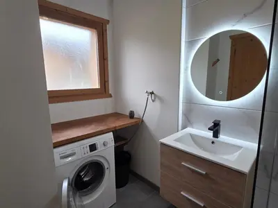 a bathroom with a sink and a washing machine at Appartement calme 2 chambres avec terrasse à Samoëns - FR-1-642-77 in Samoëns