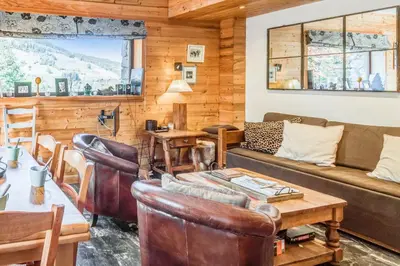 a living room with a couch and a table at Appartement Stenoga - Welkeys in Megève