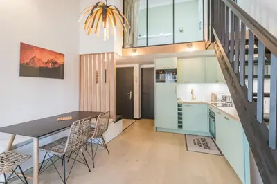 a kitchen and dining room with a table and chairs at Appartement Jorasses - Welkeys in Chamonix-Mont-Blanc
