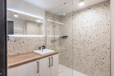 a bathroom with a sink and a glass shower at Appartement Jorasses - Welkeys in Chamonix-Mont-Blanc