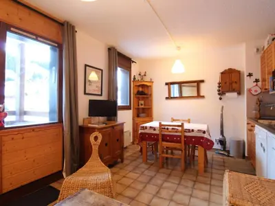 a kitchen with a table and a dining room at Studio 4 pers. avec Balcon, Proche Pistes et Commerces, Parking Inclus - Arâches-la-Frasse - FR-1-572-181 in Arâches-la-Frasse