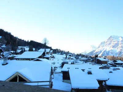 a village covered in snow with a mountain in the background at Studio 4 pers. avec Balcon, Proche Pistes et Commerces, Parking Inclus - Arâches-la-Frasse - FR-1-572-181 in Arâches-la-Frasse