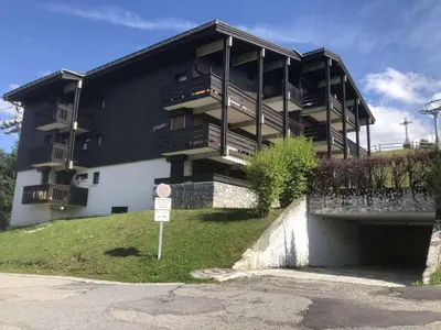 a black and white building with a sign in front of it at Studio + Alcôve 4 Couchages, Balcon, Parking, Skis - Proche Rochebrune, Megève - FR-1-597-168 in Megève