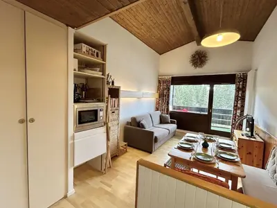 a kitchen and living room with a couch and a table at Studio + Alcôve 4 Couchages, Balcon, Parking, Skis - Proche Rochebrune, Megève - FR-1-597-168 in Megève