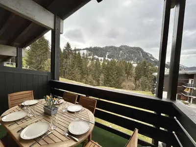 a table on a balcony with a view of a mountain at Studio + Alcôve 4 Couchages, Balcon, Parking, Skis - Proche Rochebrune, Megève - FR-1-597-168 in Megève