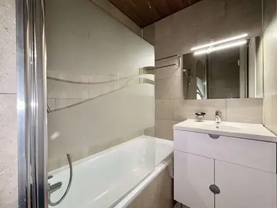 a bathroom with a tub and a sink and a bath tub at Studio + Alcôve 4 Couchages, Balcon, Parking, Skis - Proche Rochebrune, Megève - FR-1-597-168 in Megève