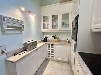 a white kitchen with white cabinets and a sink at Charmant 2 pièces, 4 couchages, Megève - À 400m des remontées mécaniques, balcon et parking inclus - FR-1-597-169 in Megève