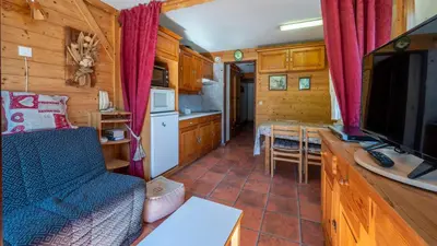 a living room with a couch and a tv and a kitchen at Grand Morillon- C215 Appt vue piste-4 pers in Morillon