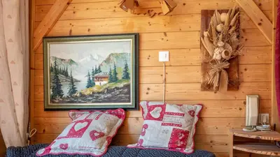 a painting on the wall of a cabin with two pillows at Grand Morillon- C215 Appt vue piste-4 pers in Morillon