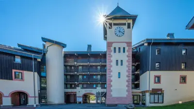 a clock tower in front of a building at Grand Morillon- C215 Appt vue piste-4 pers in Morillon