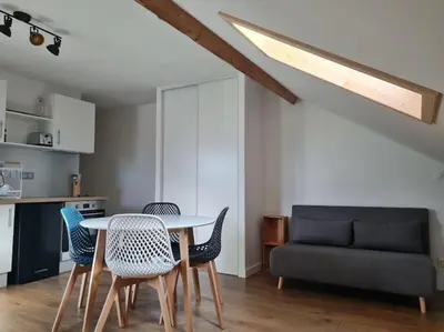 a living room with a table and chairs and a couch at Nid douillet proche des pistes avec vue montagne in Saint-Gervais-les-Bains