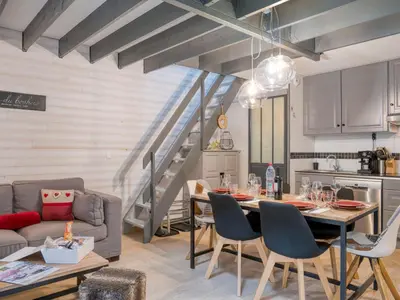 a kitchen and living room with a table and a couch at Triplex chaleureux avec wifi - 6 personnes - Proche centre - FR-1-663-6 in Saint-Gervais-les-Bains