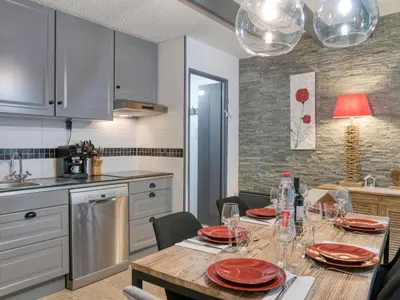 a kitchen and dining room with a table and chairs at Triplex chaleureux avec wifi - 6 personnes - Proche centre - FR-1-663-6 in Saint-Gervais-les-Bains