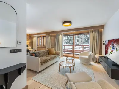 a living room with a couch and a table at Appartement neuf avec terrasse, 2 chambres près des pistes, sauna, hammam, salle de sport, parking - FR-1-569-57 in Megève