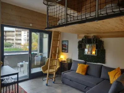 a living room with a couch and a loft at Roomy studio near town and ski lift, free WiFi and parking in Saint-Gervais-les-Bains