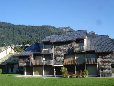 a large house with a roof with a balcony at Coquet Studio de 4 personnes aux Carroz - Balcon et Wifi in Les Carroz d'Araches