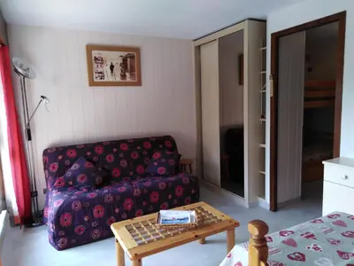 a living room with a couch and a table at Coquet Studio de 4 personnes aux Carroz - Balcon et Wifi in Les Carroz d'Araches