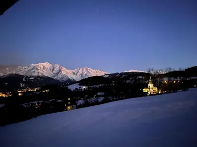 a view of a snowy mountain with snow covered mountains at Chalet à Cordon face à la chaîne du Mont Blanc in Cordon