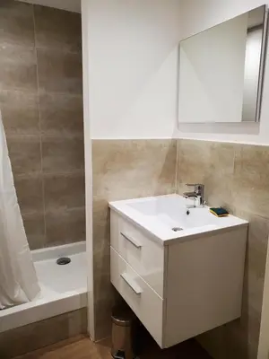 a bathroom with a sink and a mirror and a tub at Chalet à Cordon face à la chaîne du Mont Blanc in Cordon
