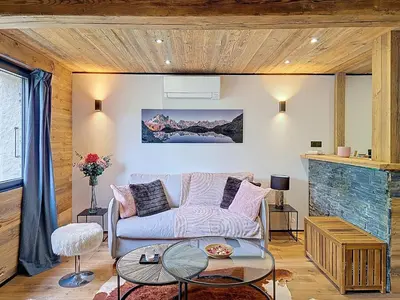 a dining room with a table and fur chairs at Logement à Megève avec Jardin in Megève