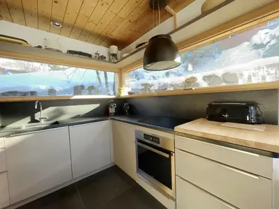a small kitchen with white cabinets and a sink at Chalet indépendant 8 pers, déco moderne, proche centre et remontées, terrasse sud-ouest - FR-1-572-32 in Arâches-la-Frasse