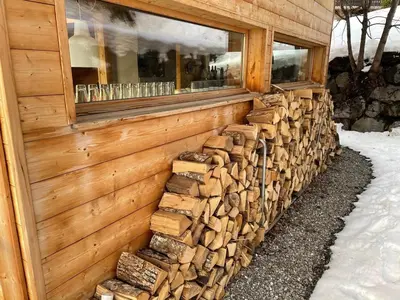 a pile of wood on the side of a building at Chalet indépendant 8 pers, déco moderne, proche centre et remontées, terrasse sud-ouest - FR-1-572-32 in Arâches-la-Frasse