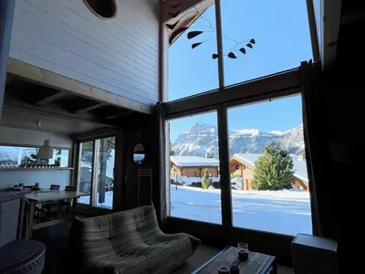 a living room with a large window with a view of mountains at Chalet indépendant 8 pers, déco moderne, proche centre et remontées, terrasse sud-ouest - FR-1-572-32 in Arâches-la-Frasse