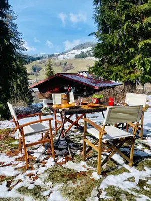 a picnic table and chairs in the snow at Megève Rochebrune, 2 chambres cosy, terrasse, ski et centre à pied in Megève