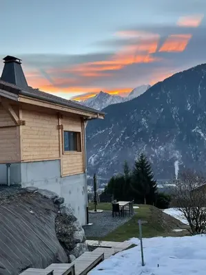 a house with a table in front of a mountain at Gîte Au Balcon de Passy/Plaine Joux, classé 2 ** in Passy
