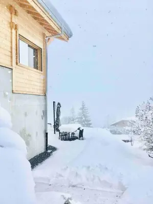 a yard covered in snow next to a building at Gîte Au Balcon de Passy/Plaine Joux, classé 2 ** in Passy
