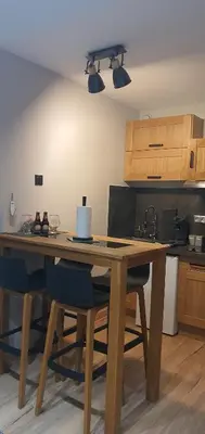 a wooden table and chairs in a kitchen at Duplex Aiguille du midi CHAMONIX in Chamonix-Mont-Blanc