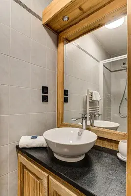 a bathroom with a sink and a mirror at Apartment le Paradis 1 - Alpes Travel - Central Chamonix (sleeps 4) in Chamonix-Mont-Blanc