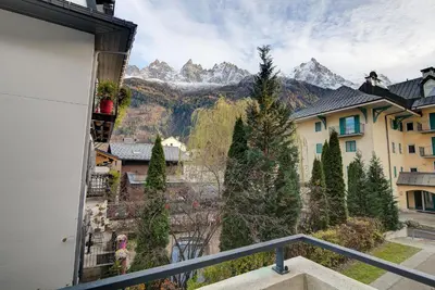 a view of the mountains from the balcony of a building at Apartment le Paradis 1 - Alpes Travel - Central Chamonix (sleeps 4) in Chamonix-Mont-Blanc