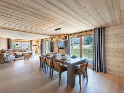 a dining room with a table and chairs at Appartement neuf spacieux à Megève avec jardin privatif - FR-1-569-60 in Megève