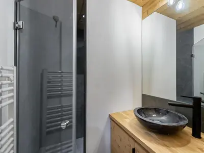 a bathroom with a black sink and a shower at Appartement neuf spacieux à Megève avec jardin privatif - FR-1-569-60 in Megève