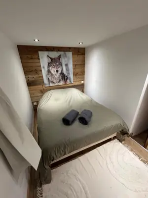 a room with a bed with a picture of a dog at Logement avec jardin et vue panoramique MontBlanc in Les Houches