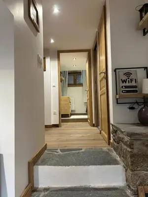 a hallway leading to a room with at Logement avec jardin et vue panoramique MontBlanc in Les Houches