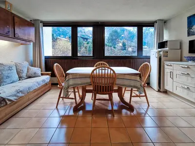 a kitchen with a table and chairs and a couch at Sun Valley 3 - Vue Mont-Blanc in Chamonix-Mont-Blanc