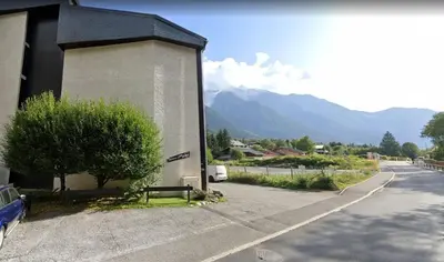 a building with a bench on the side of a road at Sun Valley 3 - Vue Mont-Blanc in Chamonix-Mont-Blanc
