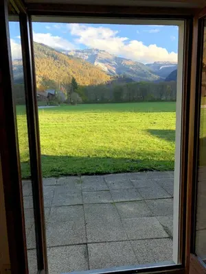 a view of a field from a sliding glass door at Studio - Le D2 du Grand Tetras in Samoëns